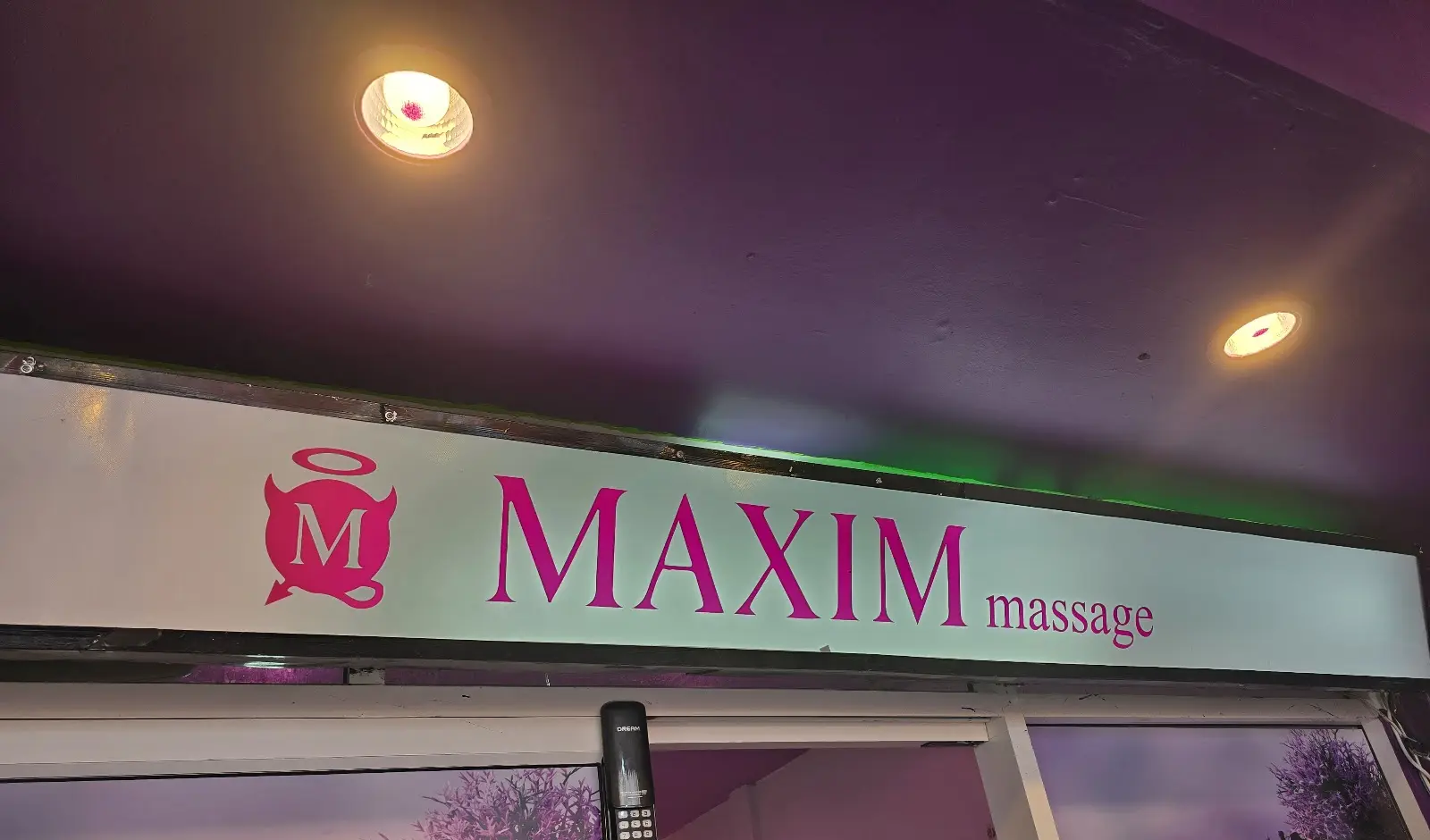 The MAXIM massage sign above the shop entrance on Sukhumvit Soi 22